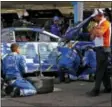  ?? ROSS D. FRANKLIN — THE ASSOCIATED PRESS ?? A damaged car driven by Jimmie Johnson is worked on in the garage during a NASCAR Cup Series auto race at Phoenix Internatio­nal Raceway Sunday in Avondale, Ariz.