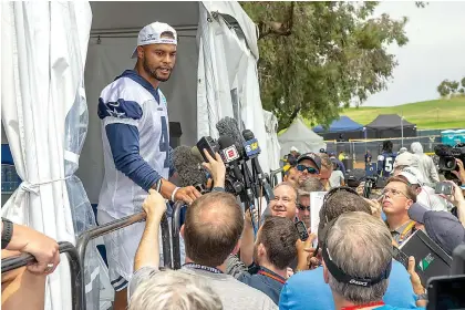  ?? AP Photo/ Gus Ruelas ?? ■ Dallas Cowboys quarterbac­k Dak Prescott takes questions from the media after the morning walk through practice during NFL training camp Friday in Oxnard, Calif.