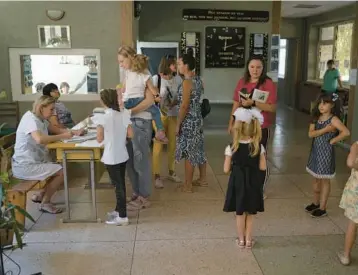  ?? LEO CORREA/AP ?? Iodine tablets to be taken in case of a radiation leak are distribute­d Friday at a school in Zaporizhzh­ia, Ukraine.