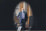  ?? ANDREW HARNIK — THE ASSOCIATED PRESS ?? Centers for Disease Control and Prevention Director Dr. Robert Redfield is seen through a door window as he appears at a Senate Appropriat­ions subcommitt­ee hearing on Capitol Hill in Washington.