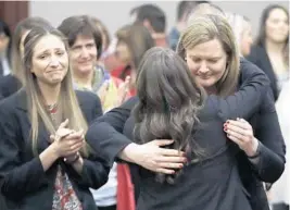  ?? CARLOS OSORIO/AP ?? Victims react and hug Assistant Attorney General Angela Povilaitis after Larry Nassar was sentenced Wednesday in Lansing, Mich. The judge said Nassar was a continuing danger.