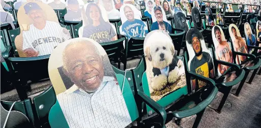  ?? MORRY GASH THE ASSOCIATED PRESS ?? The Brewers had fan cutouts ready for their home opener on Friday, but the game was postponed after two Cardinals players tested positive for the coronaviru­s.