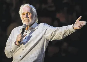  ?? Suzanne Cordeiro / AFP / Getty Images 2017 ?? Country balladeer Rogers, shown performing in Austin, Texas, on his 2017 farewell tour, sold tens of millions of records, won three Grammys and starred in TV movies based on his songs.