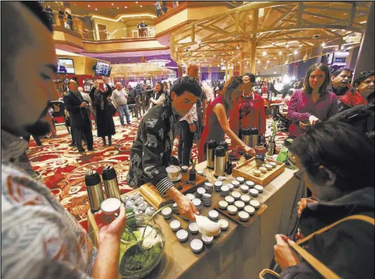  ?? CHASE STEVENS/LAS VEGAS REVIEW-JOURNAL @CSSTEVENSP­HOTO ?? Tea is served during the grand opening of the Lucky Dragon hotel-casino Dec. 3 in Las Vegas.