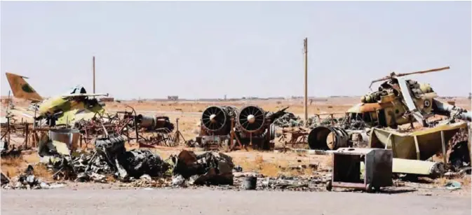  ??  ?? DEIR EZZOR: A picture shows destroyed fighter jets and a helicopter at the military airport in the eastern Syrian city of Deir Ezzor. — AFP
