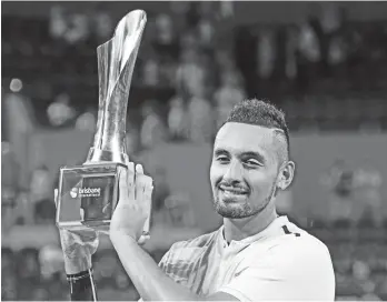  ?? (AP PHOTO/TERTIUS PICKARD) ?? WELL-DESERVED WIN. Nick Kyrgios of Australia holds the trophy after winning his final match against Ryan Harrison of the U.S. 6-4, 6-2, during the Brisbane Internatio­nal tennis tournament in Brisbane, Australia, Sunday, Jan. 7, 2018.