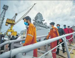  ?? PRATIK CHORGE/HT PHOTO ?? Crew members of ONGC'S Barge P305 who were stranded off the Mumbai shore come out of INS Kochi on Wednesday after they were rescued by the Indian Navy.