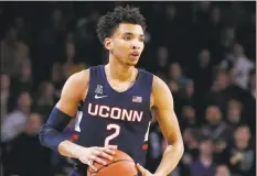  ?? Sue Ogrocki / Associated Press ?? James Bouknight and the UConn men’s basketball team take on Cincinnati on Sunday in Storrs.