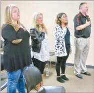  ?? Westside Eagle Observer/SUSAN HOLLAND ?? Glenn Duffy Elementary School teachers and their principal, Zane Vanderpool, lead the pledge of allegiance to open the March meeting of the Gravette School Board. Pictured are Jennifer Davis (left), Faith Hendricks, Kristy Sanders and Vanderpool. The three teachers were recognized for achieving National Board Certificat­ion, the most respected profession­al certificat­ion in K-12 education.