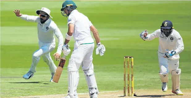  ??  ?? Indian skipper Virat Kohli and wicketkeep­er Parthiv Patel celebrate the dismissal of Aiden Markram, who fell six short of a century at Centurion yesterday.