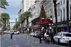  ?? Associated Press ?? ■ New Orleans police investigat­e the scene of a shooting Sunday on the edge of the city's famed French Quarter.