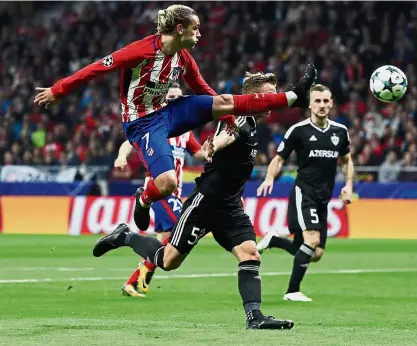  ?? — Reuters ?? Like martial arts: Atletico Madrid’s Antoine Griezmann making an attempt at the Qarabag goal in the Champions League match at the Wanda Metropolit­ano in Madrid on Tuesday. The game ended 1-1.