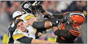  ?? (AP file photo) ?? Cleveland Browns defensive end Myles Garrett (right) hits Pittsburgh Steelers quarterbac­k Mason Rudolph with a helmet during their November 2019 meeting. As the teams get set to face off again Sunday, both players want only to put the incident past them.