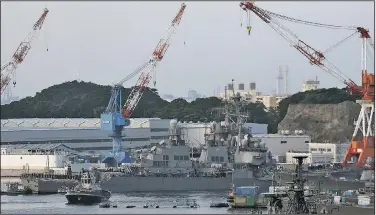  ?? AP/EUGENE HOSHIKO ?? The USS Fitzgerald arrives for repairs Saturday at Yokosuka Naval Base, Japan, as officials worked to determine the cause of the destroyer’s collision with the ACX Crystal cargo ship in a busy sea lane.