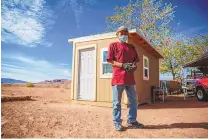  ?? COURTESY OF NILAYA SABNIS ?? A worker stands outside a completed COVID-19 shelter in the Kayenta, Ariz., region of the Navajo Nation.