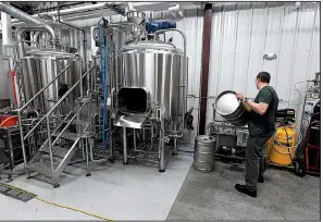  ?? NWA Democrat-Gazette/J.T. WAMPLER ?? Will Sonneman, head brewer at Natural State Beer, cleans kegs last week.