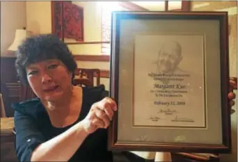  ?? PEG DEGRASSA — DIGITAL FIRST MEDIA ?? Restaurant owner Margaret Kuo holds up the award she received from the James Beard Foundation. Kuo was a guest chef several times for the prestigiou­s organizati­on based in New York. Kuo and her restaurant­s have won countless awards, including a four...