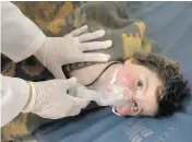  ?? IDLIB MEDIA CENTER VIA THE ASSOCIATED PRESS ?? A child is treated at a makeshift hospital following a suspected chemical attack in the Syrian town of Khan Sheikhoun on Tuesday. At least 11 children were killed.