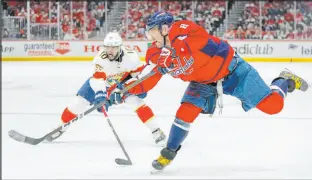  ?? Alex Brandon The Associated Press ?? Capitals left wing Alex Ovechkin shoots in front of Panthers right wing Anthony Duclair in Washington’s 6-1 win Saturday at Capital One Arena.