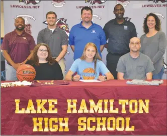  ?? Submitted photo ?? NIGHTHAWK SIGNING: Lake Hamilton graduate Logan Keener, seated center, recently signed a letter of intent to play basketball for National Park College. She was joined in front by her mother, Becki Keener, left, and Brian Keener, and back, from left,...