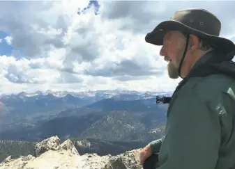  ?? Denese Stienstra / Special to The Chronicle ?? Chronicle outdoors writer Tom Stienstra scans the view of the Sierra Crest from 10,365foot Mitchell Peak in the Jennie Lakes Wilderness. Mitchell can be summited in a day hike.