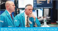  ??  ?? NEW YORK: Traders work on the floor of the New York Stock Exchange on Friday in New York City. Markets continued their downward plunge Friday as continuing fears of a Coronaviru­s pandemic prompted a sell-off, making for the worst week on Wall Street since 2008. — AFP