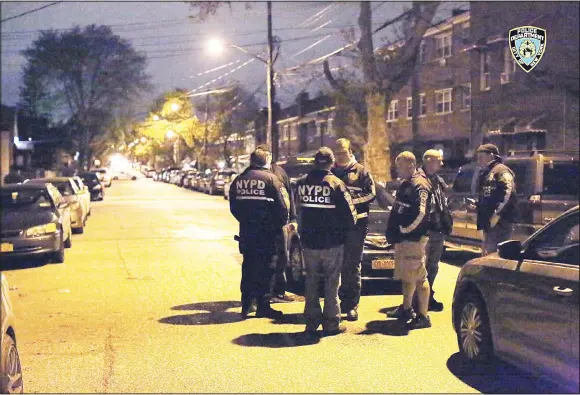  ??  ?? In this photo provided by the New York City Police Department, officers gather at a location in the Bronx borough of New York during a takedown of two rival drug gangs in the early hours of April 27. (AP)