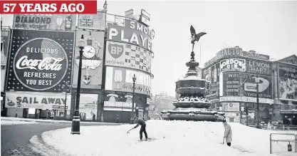  ??  ?? Standstill Workmen shovel snow at the normally-busy Piccadilly Circus in London