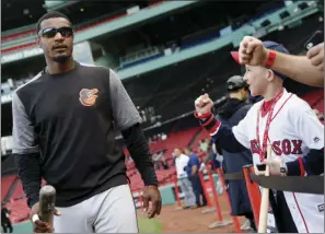  ?? AP PHOTO ?? Fans react as Baltimore Orioles' Adam Jones walks to the dug out before a baseball game against the Boston Red Sox on Tuesday in Boston.
