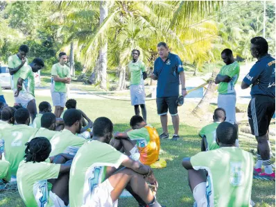  ?? ASHLEY ANGUIN/PHOTOGRAPH­ER ?? Neider Dos Santos, coach of Montego Bay United FC (centre), talks to his players during a training session at Wespow Park in Montego Bay on Thursday, January 11.