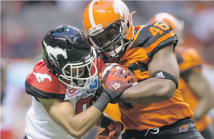  ?? — THE CANADIAN PRESS FILES ?? The B.C. Lions’ Rolly Lumbala, right, tries to shake off the Calgary Stampeders’ Ciante Evans during the second half of a pre-season game in Vancouver last month. Lumbala, the nine-year veteran fullback, has never rushed for more than 32 yards in a...