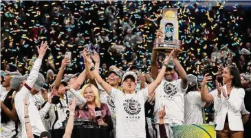  ?? Eric Gay/Associated Press ?? South Carolina coach Dawn Staley celebrates with her team after defeating UConn in the NCAA championsh­ip game on April 3 in Minneapoli­s.