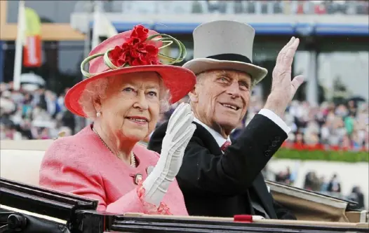  ?? Alastair Grant/Associated Press ?? Britain’s Queen Elizabeth II and her husband, Prince Philip, arrive by horse-drawn carriage in the parade ring on the third day, traditiona­lly known as Ladies Day, of the Royal Ascot horse race meeting at Ascot, England, on June 16, 2011. Philip died Friday at the age of 99.