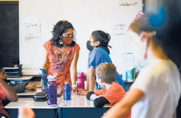  ?? MATT ROURKE/AP ?? Student teacher Olivia Vazquez, left, is finishing up her degree. The 27-year-old hopes to ensure that immigrant students arriving in Philadelph­ia have a more supportive experience in school than she did while growing up.