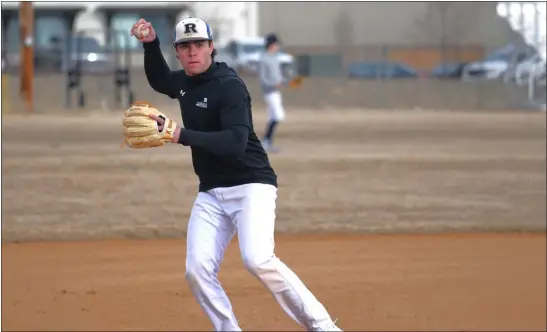  ?? NATHAN WRIGHT — LOVELAND REPORTER-HERALD ?? Resurrecti­on Christian senior third baseman and pitcher Carter Evans throws a ball back during practice last Friday at RCS. Carter is the leading returner in most offensive categories for the Cougars this season.