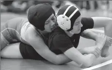  ?? BEA AHBECK/NEWS-SENTINEL ?? Tokay's Yesenia Ruiz wrestles Armojo's Dyanna Gutierrez during the 128pound third-place match during the girls wrestling championsh­ip at McNair High on Saturday.