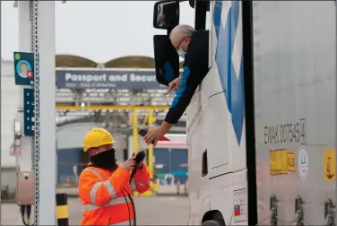  ?? (AP/Frank Augstein) ?? A truck driver’s documents are scanned as he passes a checkpoint in Folkestone, England, in January.