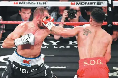  ?? ETHAN MILLER / AFP ?? Andre Ward (right) lands a left hook on Sergey Kovalev during their light-heavyweigh­t bout at Mandalay Bay Events Center on Saturday in Las Vegas, Nevada. Ward retained his WBA, IBF and WBO titles with an eighth-round TKO.