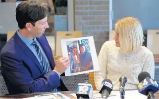  ?? AMY BETH BENNETT/SUN SENTINEL ?? Attorney Todd Falzone holds a photo of Jennifer St. Clair with her brother and nephew as her aunt, Amy Gamber, speaks about her during a news conference at Kelley Uustal, a law firm in Fort Lauderdale, on Tuesday.