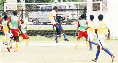  ??  ?? Jeremy Garrett (jumping) of Chase Academy rising high to meet a right side cross against Pure Masters The Milo Secondary Schools Football Championsh­ip at the Ministry of Education ground. (Orlando Charles photo)