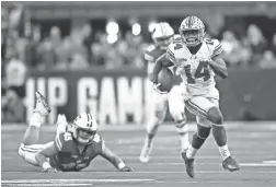  ?? GETTY IMAGES ?? Ohio State wide receiver K.J. Hill (14) runs the ball against Wisconsin’s Alec Ingold (45) in the second half during the Big Ten Championsh­ip game at Lucas Oil Stadium on Saturday.