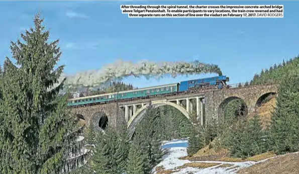  ??  ?? After threading through the spiral tunnel, the charter crosses the impressive concrete-arched bridge above Telgart Penzionhal­t. To enable participan­ts to vary locations, the train crew reversed and had three separate runs on this section of line over the viaduct on February 17, 2017. DAVID RODGERS