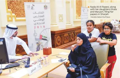  ?? Virendra Saklani/Gulf News ?? Nada Ali Al Raeesi, along with her daughters Ghala and Maryam, filing her papers in Sharjah.