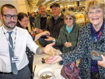  ??  ?? Pensioners collect their pounds at Trago Mills. Cathy Beard, Elliott Heywood and Sarah Kingwell joined in the festivitie­s