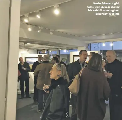  ?? BY DENNIS BRACK ?? Kevin Adams, right, talks with guests during his exhibit opening last Saturday evening.