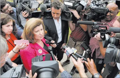  ?? Bob Andres ?? Atlanta Journal-constituti­on Karen Handel, Republican candidate for Georgia’s 6th Congressio­nal District, talks to the press at St Mary’s Orthodox Church in Roswell, Ga., after she voted. Incomplete returns show Handel winning with almost 53 percent of...