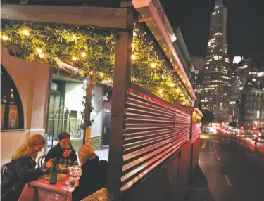  ?? Photos by Carlos Avila Gonzalez / The Chronicle ?? Customers enjoy dinner at the beloved Tosca Cafe in San Francisco, which, after being closed for more than a year and now under new ownership, has reopened for outdoor dining with an elaborate parklet.