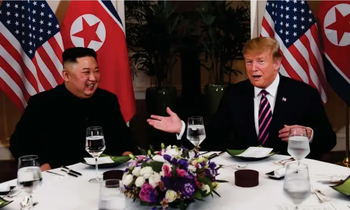  ??  ?? Kim Jong-un and Donald Trump sit down to dinner at the Metropole hotel in Hanoi. Photograph: Saul Loeb/AFP/Getty Images