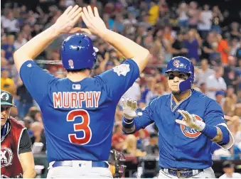  ?? RICK SCUTERI/ASSOCIATED PRESS ?? Chicago’s Javier Baez, right, celebrates with Daniel Murphy after hitting a two-run homer in the Cubs’ win over Arizona in Phoenix in Tuesday night.