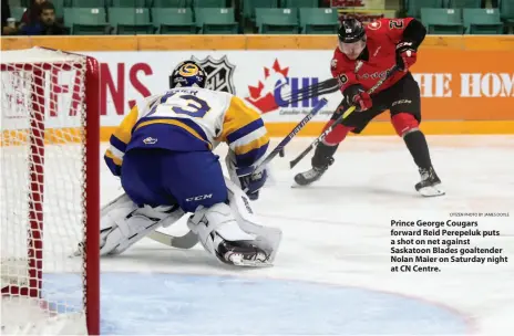  ?? CITIZEN PHOTO BY JAMES DOYLE ?? Prince George Cougars forward Reid Perepeluk puts a shot on net against Saskatoon Blades goaltender Nolan Maier on Saturday night at CN Centre.